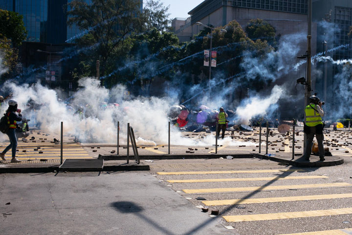Hong Kong street with clouds of teargas and rubble